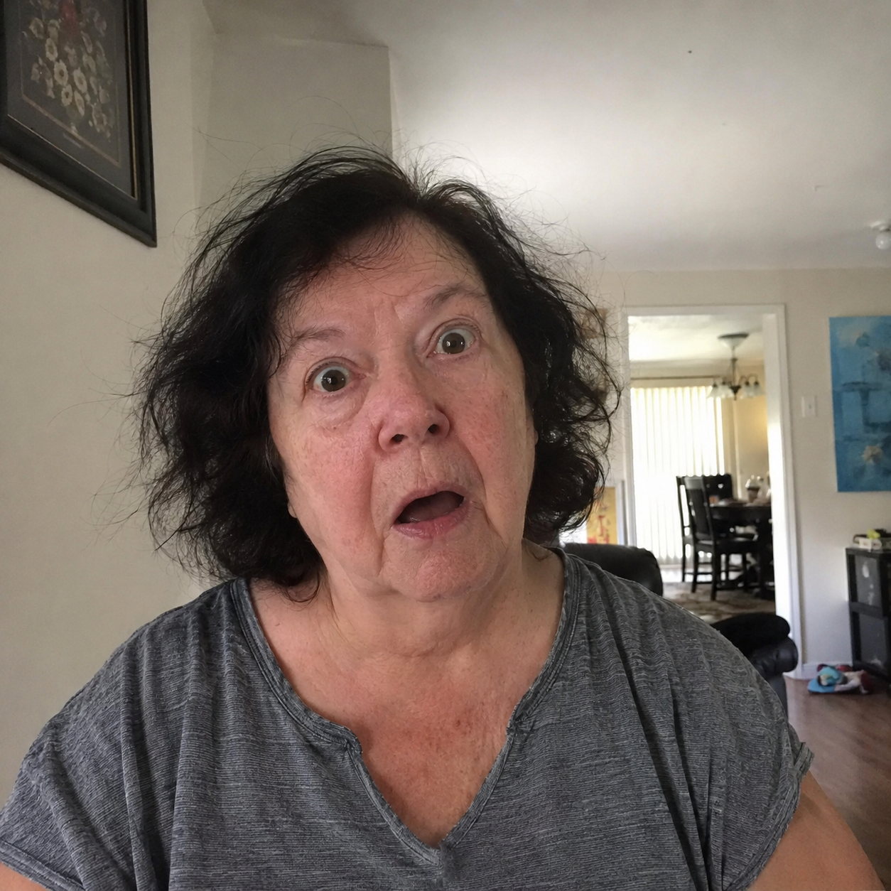 Elderly woman with a shocked expression, messy hair, before style photo.